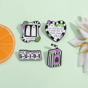 Set of four beetlejuice inspired enamel pins with stripes and movie quotes design