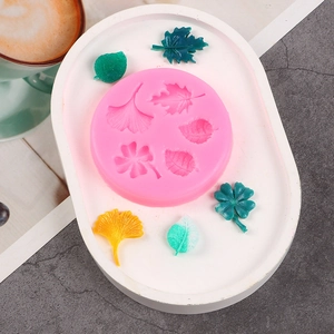Macro view of pink silicone leaf mold with ginkgo and maple leaf fondant patterns