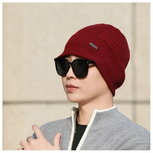 Detailed close-up of dark red ribbed knit texture and NY & JA brand label on winter hat