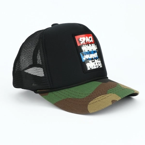 Detail of adult trucker hat featuring camo brim and breathable black mesh back