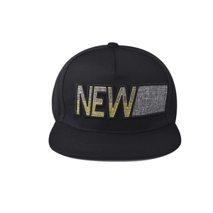 Close-up of black flat brim snapback cap with yellow and grey 3D NEW embroidery