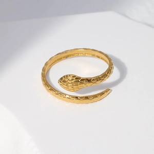 Macro view of golden snake ring showing detailed scale texture and adjustable spiral design
