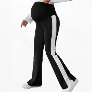 Maternity flared black trousers with belly support, white side stripes, and ankle slits