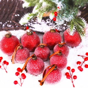 Set of 10 red glitter Christmas balls in various sizes on a festive snowy background