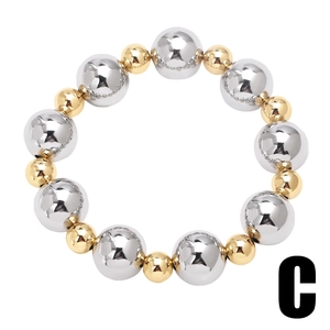 Detailed macro view of two-tone high-polish gold and silver beaded bracelet