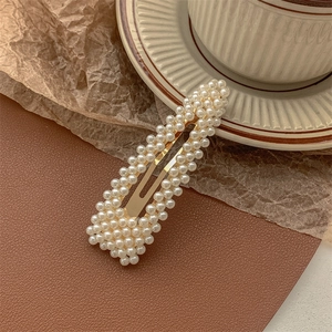 Close-up of pearl BB hair clip with gold alloy base and neat small white pearls