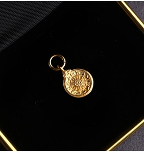 Macro shot of gold-plated S925 silver round pendant with relief texture in jewelry box