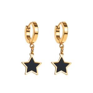 Detail of gold huggie hoop earrings with black enamel star pendants in a sleek design