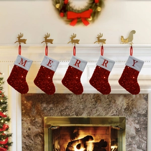 Red sequin Christmas stockings with fur trim and MERRY letter embroidery on a mantel
