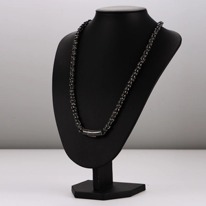 Minimalist black stainless steel chain necklace with cylindrical clasp on a model bust
