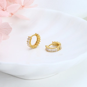 Elegant gold S925 sterling silver hoop earrings with clear baguette zircons on white ceramic