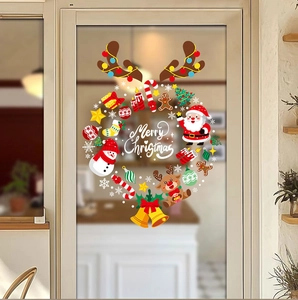 Close-up of festive Christmas stickers with Santa and snowman on a glass door