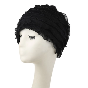 Detail of layered black ruffled turban hat with pleated soft chiffon texture for women