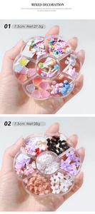 Close-up of petal-shaped storage box filled with colorful heart and bear nail art charms