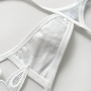 Detailed view of white floral lace underwear with breathable cotton lining and embroidery