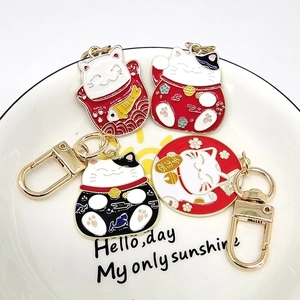 Lucky Maneki Neko keychain set with colorful enamel cat, koi fish, and fortune charms