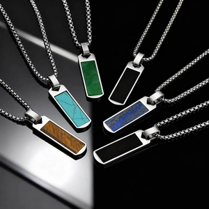 Detail of six rectangular stainless steel pendants with various natural stone inlays