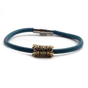 Close-up of blue leather cord bracelet with gold hollow bead and black zircon inlay