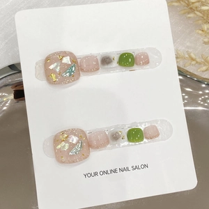 Handmade white and green press-on toenails with gold foil and shell glitter details