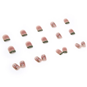 Short gradient pink press-on nails with dark green French tips and small flower patterns