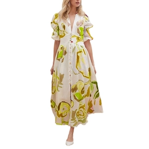 Detail of V-neckline and button-front on floral maxi dress with puff sleeves