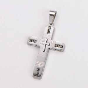 Detailed close-up of a silver stainless steel cross pendant with Greek key patterns