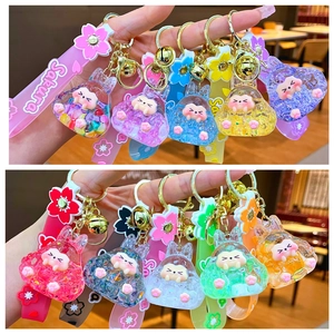 Luminous bunny liquid quicksand keychain with sakura silicone strap and gold bell accessory