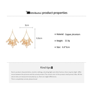 Detailed view of bohemian gold-plated teardrop fringe earrings with sparkling zircon stones