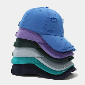 Detailed view of six distressed cotton baseball caps featuring artificial frayed edges