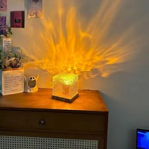 Rotating water ripple cube lamp with wood base projecting warm flame light shadows