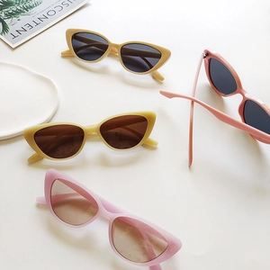 Retro cat-eye resin sunglasses for women in four trendy colors on a white tray