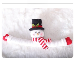 Detail of plush Christmas snowman curtain buckle with striped scarf and black top hat