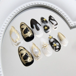 Dark gothic starfish and pearl almond press-on nails with 3D metallic gold relief accents