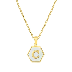 Detailed close-up of a gold hexagonal pendant with a shell inlay and metal letter C