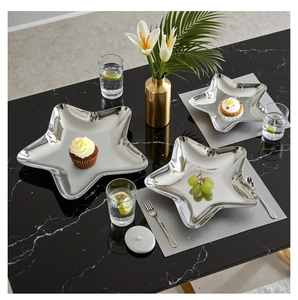Mirror polished star shaped metal serving trays set on luxury marble dining table