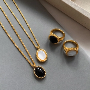 Vintage gold-plated jewelry set with black onyx and white mother of pearl pendants and rings