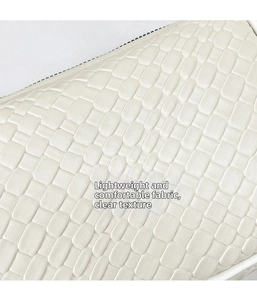 Macro detail of the woven texture and white zipper on the leather dumpling shoulder bag