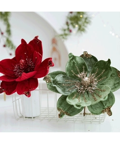 Detail of red and green velvet Christmas magnolia flowers with gold glitter in a white basket