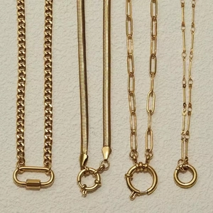 Set of four unique golden stainless steel necklaces with various chain link styles