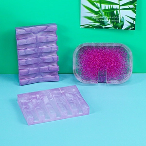 Macro shot of resin soap dishes with marble patterns and glitter flakes