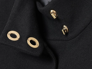 Macro view of French style houndstooth jacket collar with golden metal swivel button lock