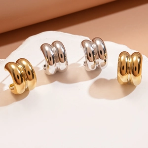 Detail showing high-gloss gold and silver chunky double-layer C-shape hoop earrings