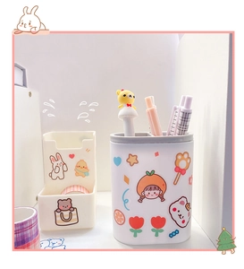 Close-up of cute rabbit and bear stickers on a cream desk organizer set for stationery