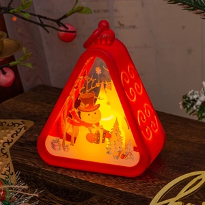 Detail of red Christmas LED lantern featuring a snowman illustration and warm lighting