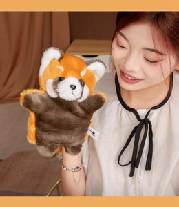 Macro shot of fluffy red panda plush hand puppet with realistic fur and brand label detail