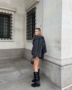 Detailed street style of loose wool coat with matching scarf and buckle boots