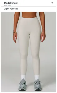 Macro shot of high-waist light apricot yoga pants featuring reinforced stitching and elastic fabric