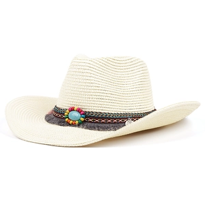Detailed view of handmade linen panama hat with turquoise stone and ethnic tassels