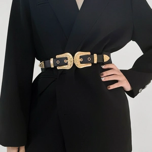 Close-up of western style black leather belt with golden double buckles on a suit