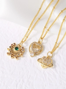 Detailed close-up of gold necklaces with heart pendants and starburst sparkling crystals